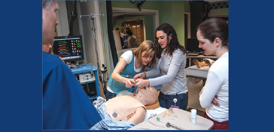 Second-year medical students learn how to intubate a mannequin “patient” under the guidance of William McIvor (Res ’94), WISER’s  associate director for medical student programs.