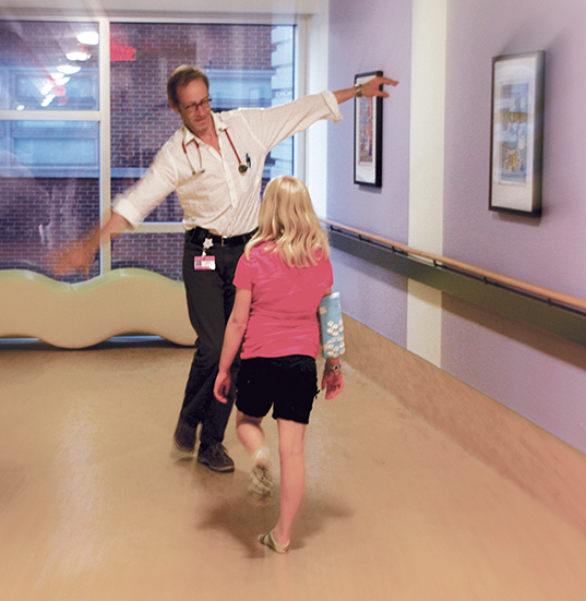 Kietz tries balancing with Julianne as he checks on her muscle strength and coordination in July.